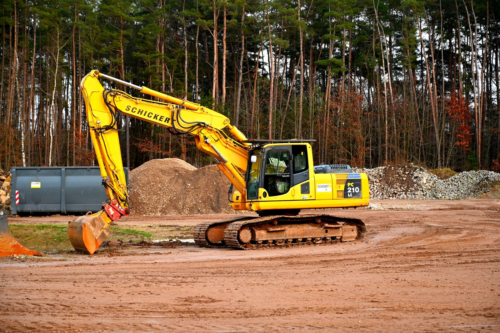 Excavator clearing land