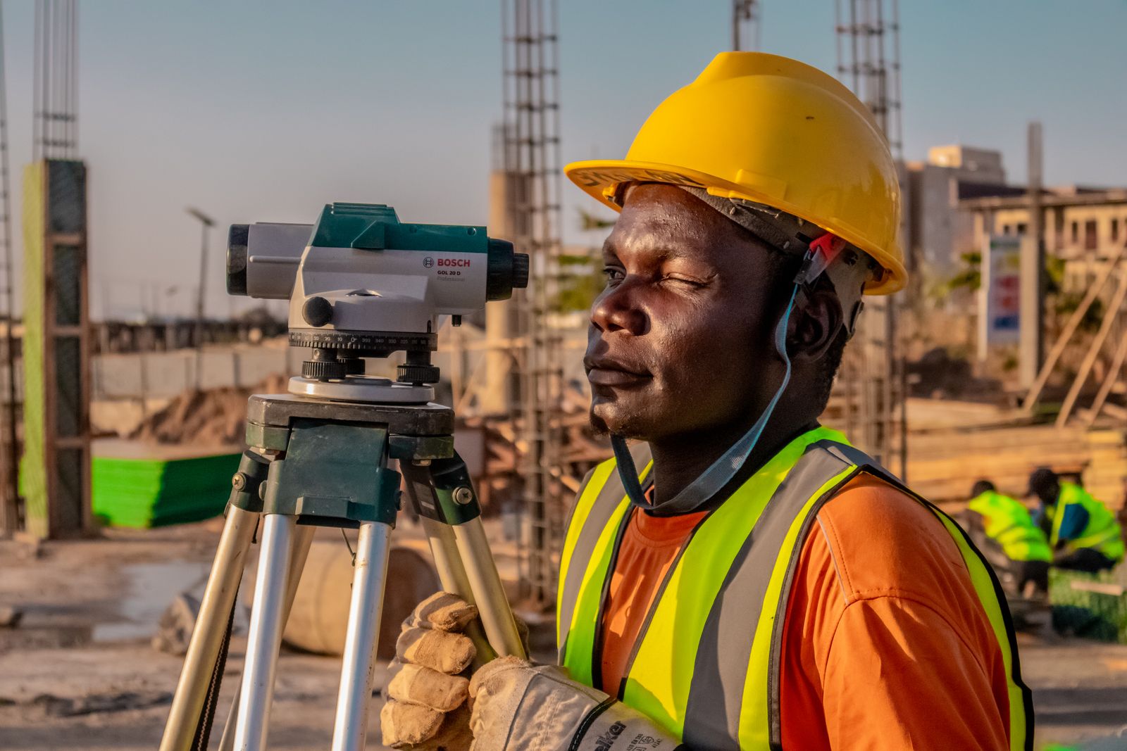 Engineer using survey level on site